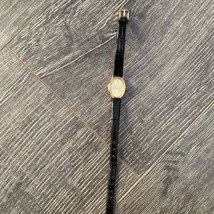 Black and gold Timex watch